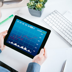 Businessman looking at a graph on his tablet