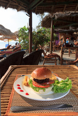 Hamburger and french fries in beach cafe