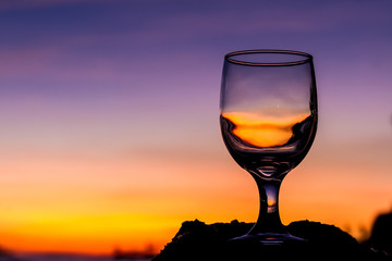 tropical sunset on beach reflected in a wine glass, summertime v
