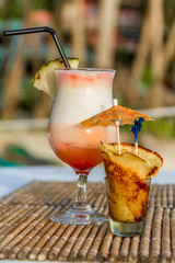 pina colada cocktail on tropical outdoor background