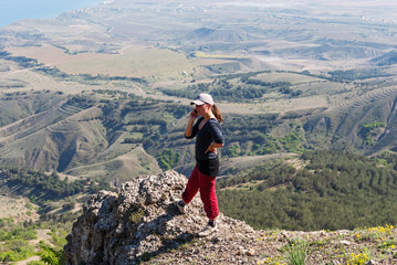 Girl talking on the phone in the mountains