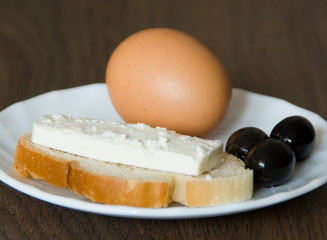 Egg, peace of white bread, cottage cheese and black olives