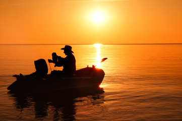 Fisherman silhouette in a beautiful sunlight