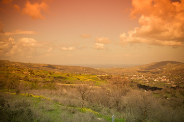 Idyllic Mediterranean landscape with mountains, clouds, trees an