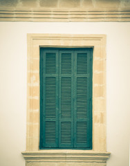 Old green window with closed shutters