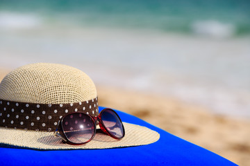 hat and sunglasses on tropical beach