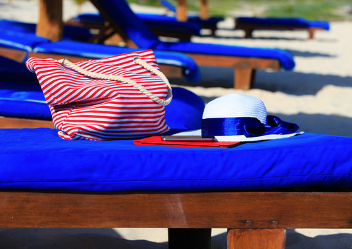 Hat, Bag, Touch Pad, Mobile Phone On Tropical Beach