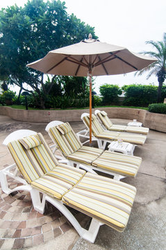line of chair lounges in the pool