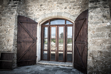 Door with shuttered in an old stone building