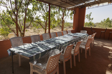 Long table and chairs on veranda. Turmi. Ethiopia. Africa.