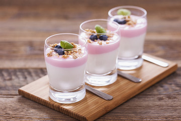 Delicious dessert, flakes flooded in two flavors yogurt with blu