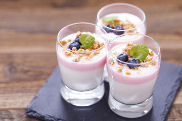 Delicious dessert, flakes flooded in two flavors yogurt with blu