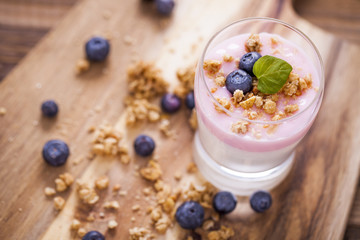 Delicious dessert, flakes flooded in two flavors yogurt with blu