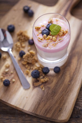 Delicious dessert, flakes flooded in two flavors yogurt with blu