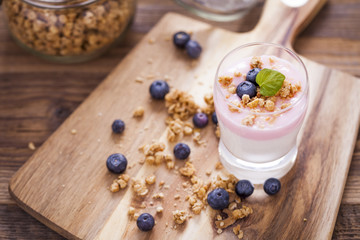 Delicious dessert, flakes flooded in two flavors yogurt with blu