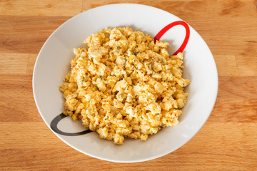 Scrambled eggs with cheese and basil.