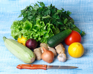 vegetables and  knife on а blue wooden table