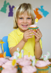 Smiling  little boy with cupcakes in Easter scene