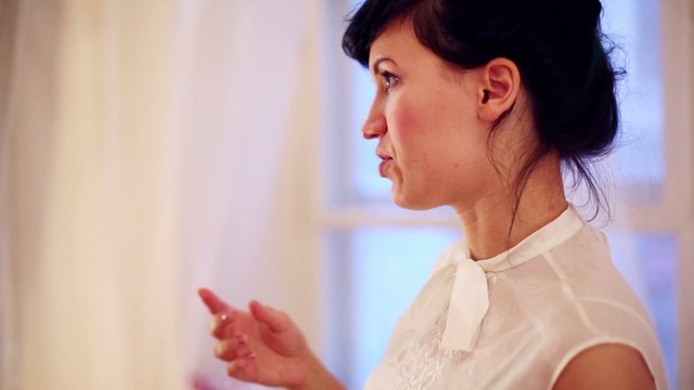 Beautiful brunette woman in white blouse enthusiasm tells