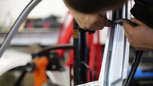 Mechanic of service station unmount seal from car door
