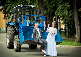 newlyweds on a tractor in park
