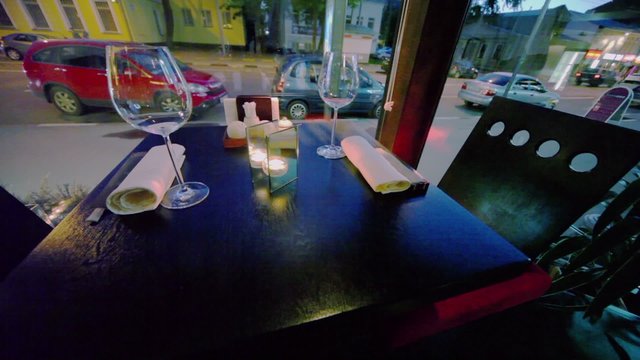 Table in restaurant and street traffic behind window