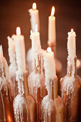 Gold bottle with burning candles