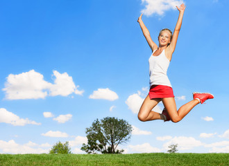 Sporty woman jumping high in air