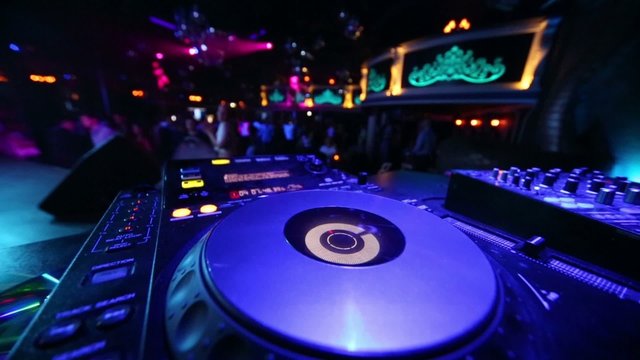DJ CD-player at workplace in nightclub during music party