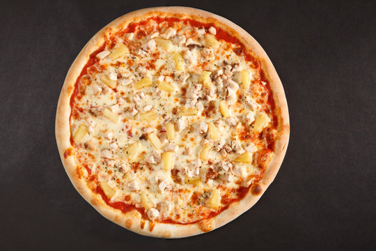 Tasty Italian pizza with pineapple chicken and cheese