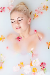 Beautiful woman in a milk bathtub