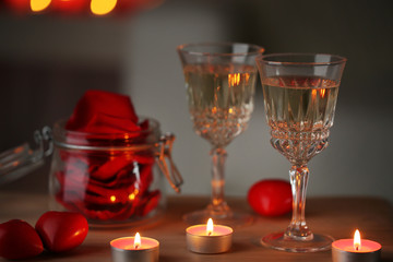 Champagne glasses and rose petals for celebrating Valentines