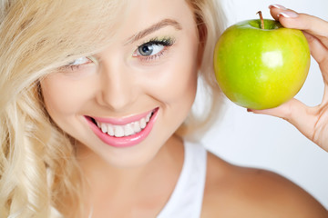 Portrait of beautiful woman with apple