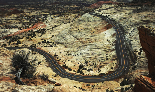 View from above of a winding road through the Utah desert landscape.