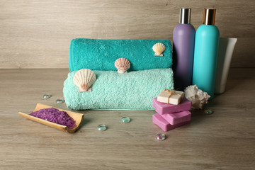 Obraz na płótnie Canvas Spa composition with towels and sea salt on wooden background