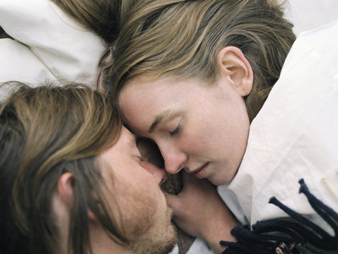 Close up of young couple sleeping.