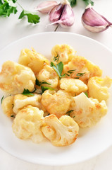 Fried cauliflower on white plate