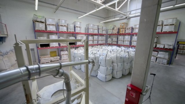 Warehouse with lot of big white sacks in Caparol factory
