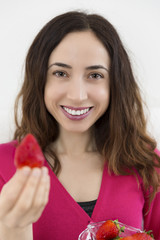 Woman showing strawberry