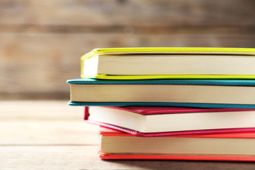 Colorful notebooks on old wooden table