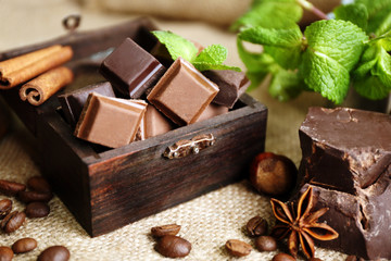 Still life with set of chocolate on burlap cloth, closeup