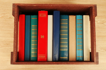 Books in wooden box, top view