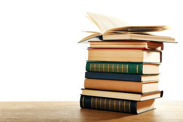 Old books on wooden table isolated on white