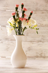 Beautiful spring flowers on wooden background