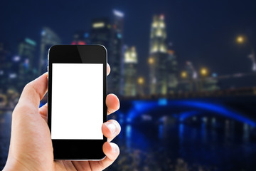 close up hand holding phone on blurred cityscape background