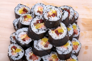 sushi fresh maki rolls isolated on wooden board