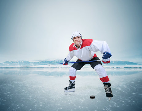 Hockey player on the ice surface of lake