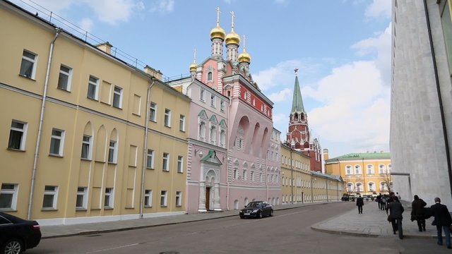 Governmental car ride by street with pedestrians