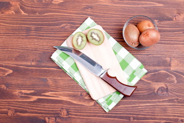 ripe delicious sliced kiwi on a board with a napkin