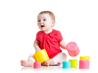 funny baby playing with colourful cup toys, isolated over white